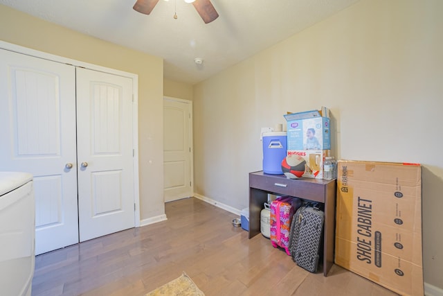 interior space with light wood-type flooring, baseboards, and a ceiling fan