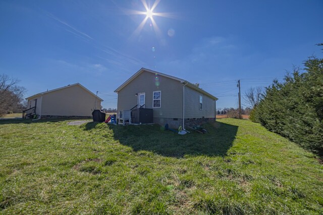 view of property exterior with crawl space and a lawn