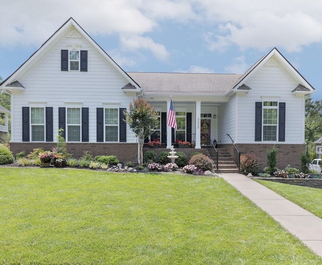 view of front of house featuring a front yard and brick siding