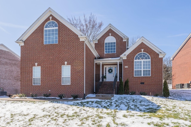 traditional-style home with crawl space, brick siding, and central air condition unit