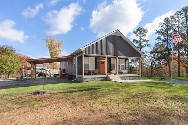 view of front of property with driveway, a porch, a carport, and a front yard