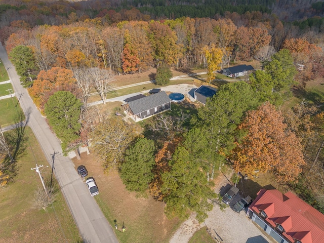 birds eye view of property featuring a wooded view