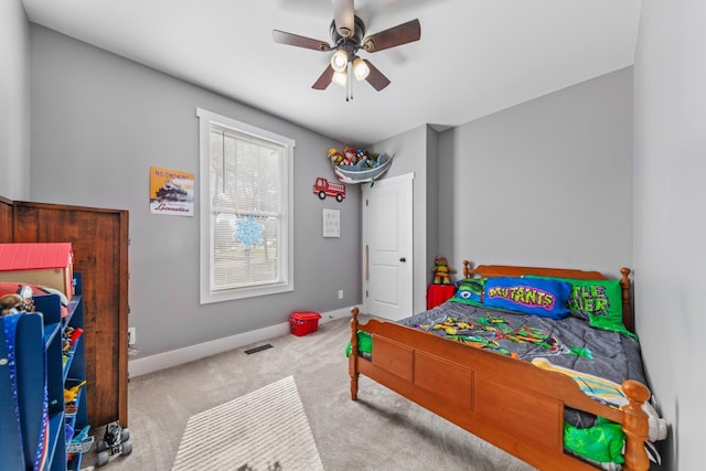 bedroom featuring light carpet, ceiling fan, and baseboards