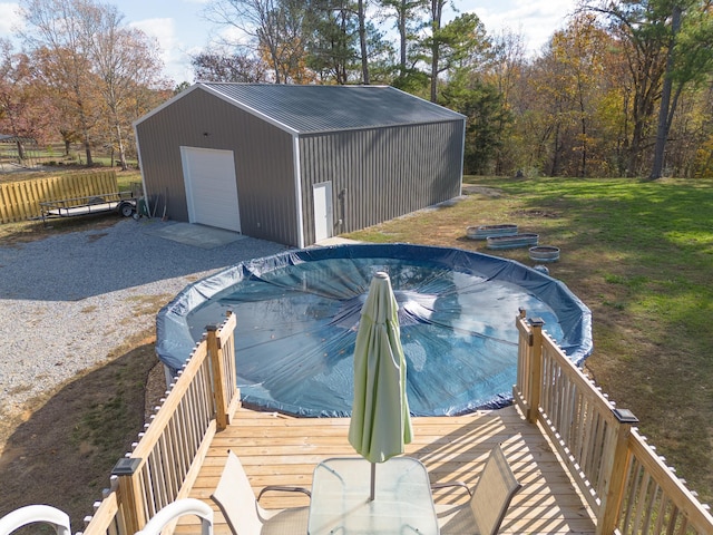 view of swimming pool with an outbuilding, a yard, and fence