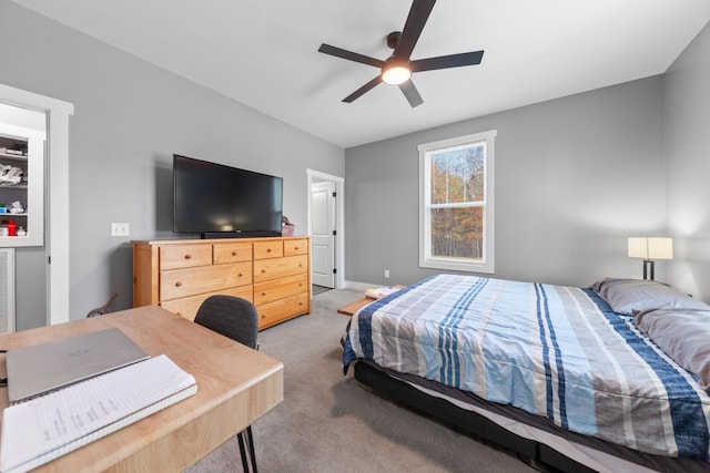 bedroom featuring a ceiling fan, light colored carpet, and baseboards