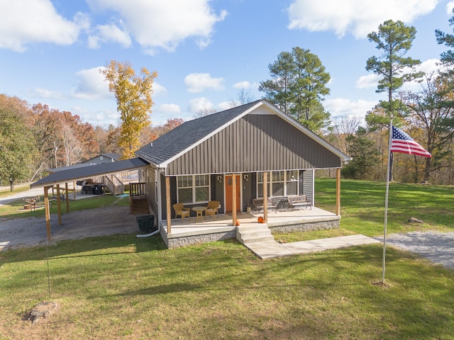 view of front of property with a front lawn and a carport