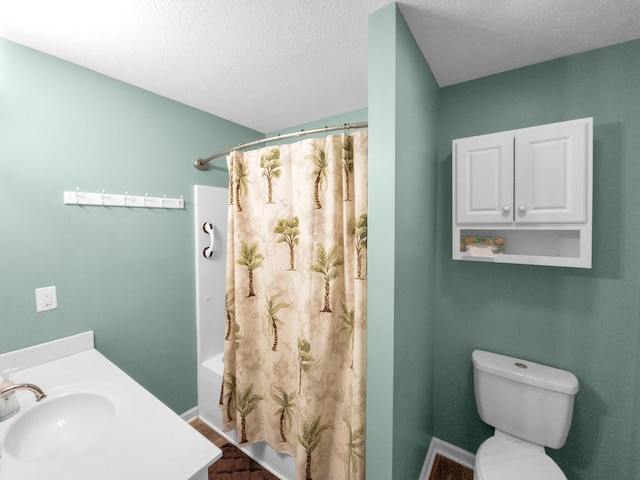 bathroom featuring toilet, shower / bath combo, a textured ceiling, vanity, and baseboards