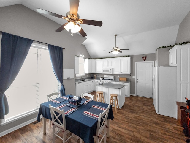 dining area with lofted ceiling, a ceiling fan, and dark wood-style flooring