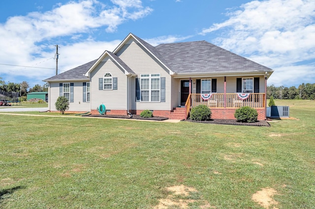 ranch-style house featuring covered porch, a shingled roof, crawl space, and a front yard