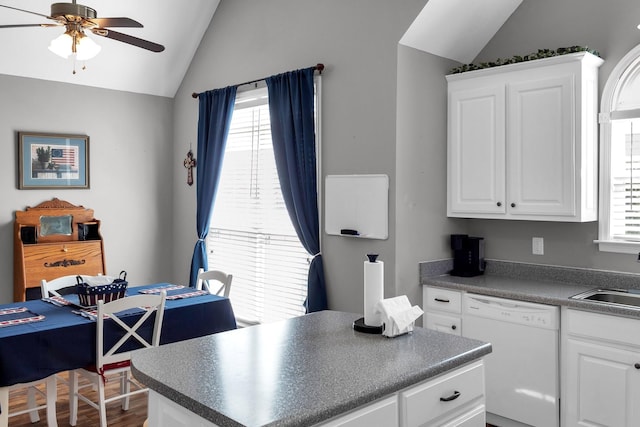 kitchen with lofted ceiling, white dishwasher, white cabinetry, a ceiling fan, and dark countertops