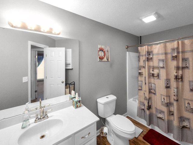 bathroom with shower / bathtub combination with curtain, toilet, vanity, a textured ceiling, and wood finished floors