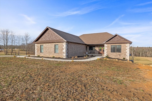 view of front of property featuring a front lawn and brick siding