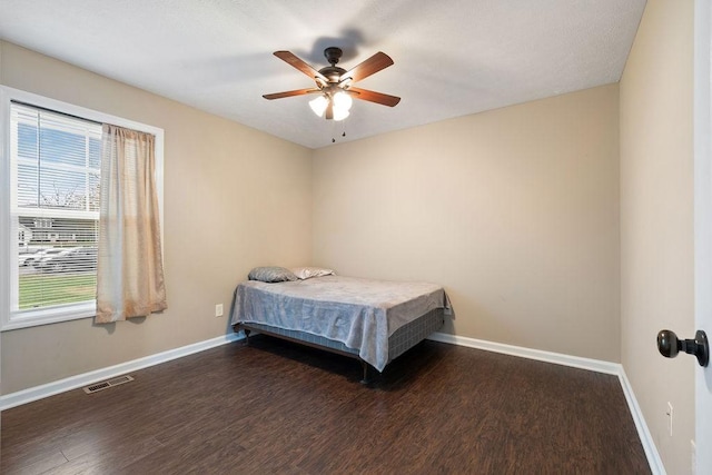 bedroom featuring dark wood-style floors, visible vents, and baseboards