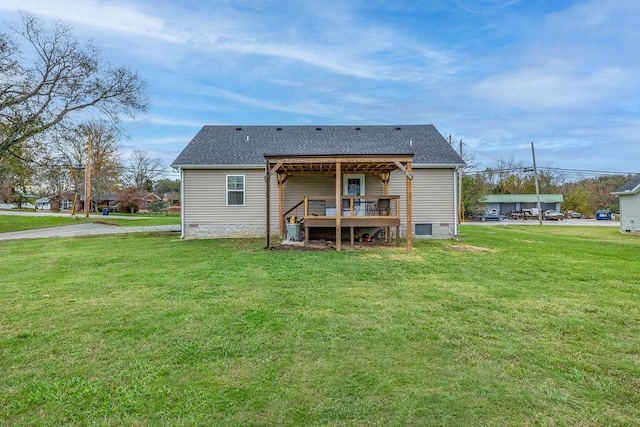 back of property with a shingled roof, crawl space, a yard, and a wooden deck