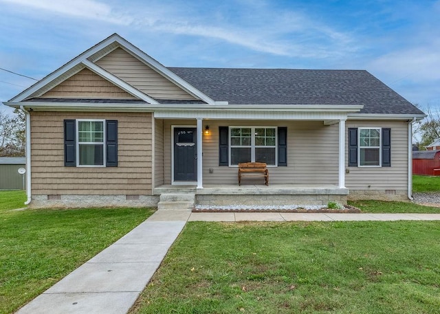 view of front of home featuring a porch, crawl space, a shingled roof, and a front lawn