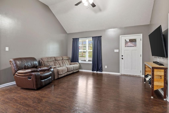 living room featuring lofted ceiling, dark wood-style floors, a ceiling fan, and baseboards