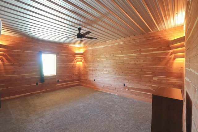 carpeted spare room with wooden walls