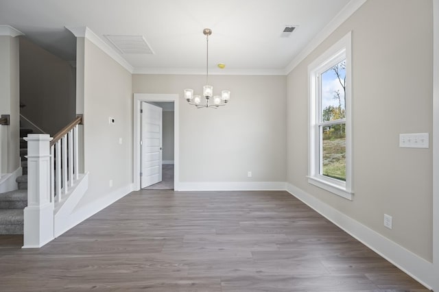 unfurnished dining area featuring ornamental molding, stairway, wood finished floors, and baseboards