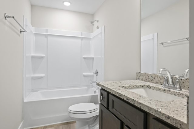 bathroom featuring toilet, shower / bathtub combination, and vanity