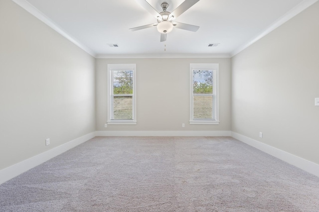 unfurnished room featuring baseboards, light carpet, visible vents, and crown molding