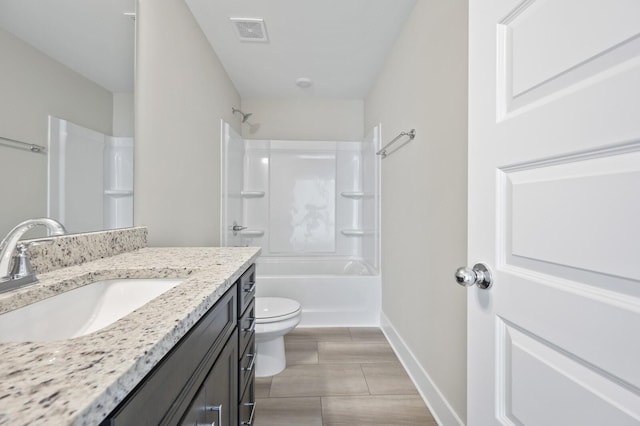 full bath with toilet, vanity, visible vents, baseboards, and shower / bathing tub combination