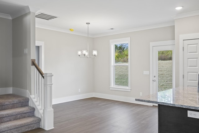 unfurnished dining area with dark wood-style flooring, visible vents, baseboards, stairs, and ornamental molding