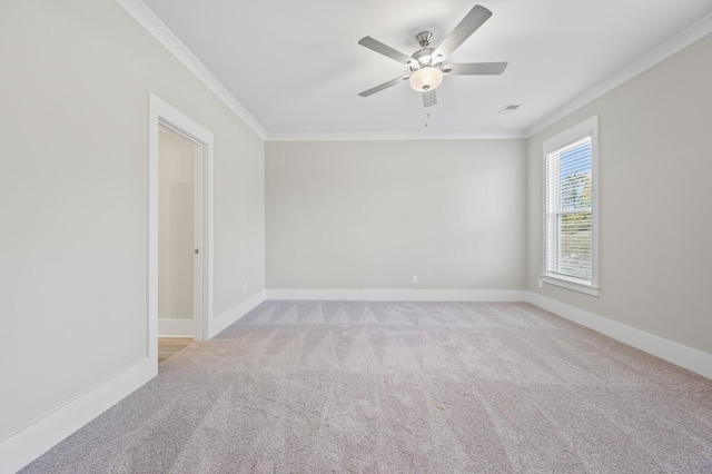 spare room with baseboards, light carpet, visible vents, and crown molding