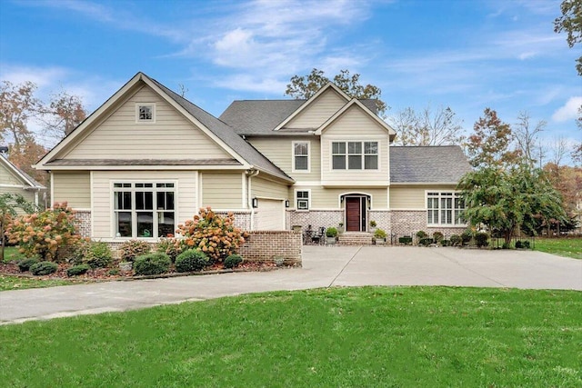 craftsman-style house featuring a garage, concrete driveway, brick siding, and a front lawn