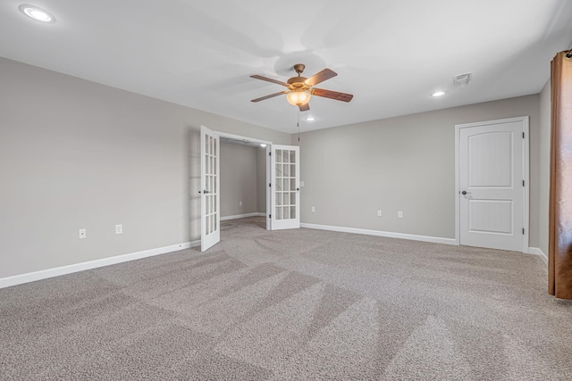 unfurnished room with french doors, carpet, visible vents, and baseboards