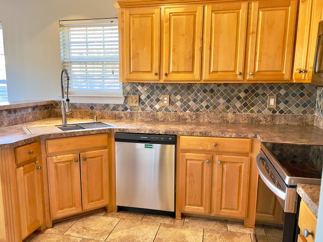 kitchen with brown cabinets, backsplash, stainless steel appliances, and a sink