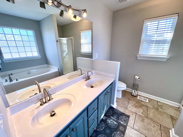 full bathroom with a garden tub, a sink, and visible vents