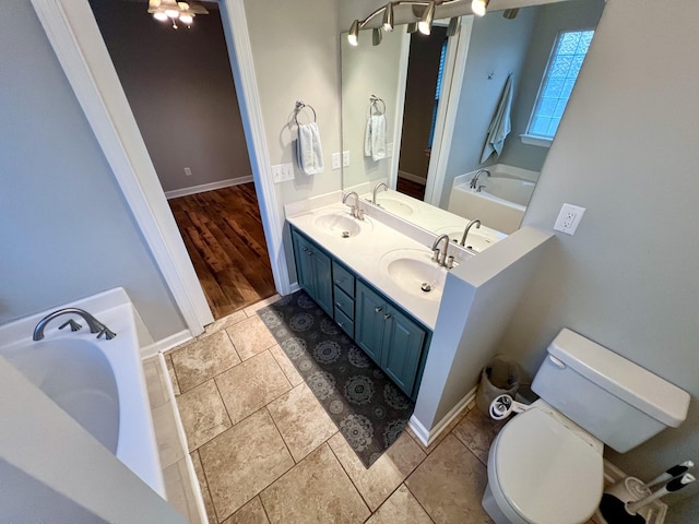 bathroom with a sink, toilet, and a bath