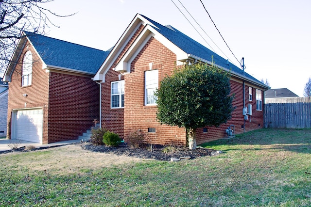 view of side of home featuring a garage, brick siding, fence, a yard, and crawl space