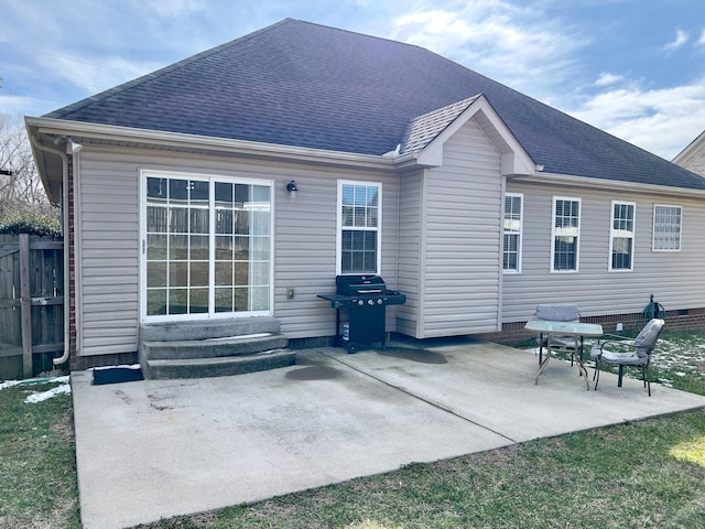 rear view of house featuring a shingled roof, entry steps, and a patio area