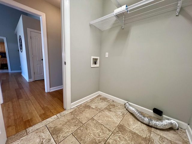 clothes washing area featuring laundry area, hookup for a washing machine, and baseboards