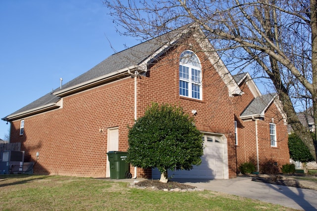 view of home's exterior with brick siding, driveway, and an attached garage