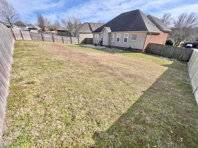 view of yard with a patio area and a fenced backyard