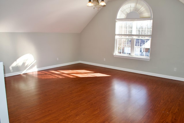 additional living space featuring lofted ceiling, baseboards, and dark wood-type flooring