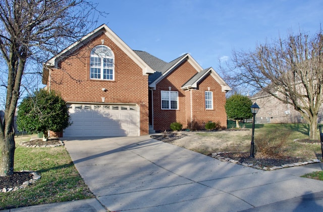 traditional-style house featuring driveway, a garage, and brick siding