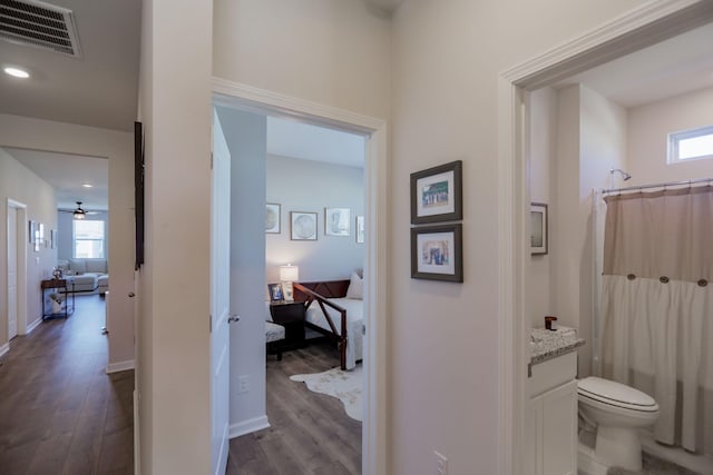 full bath with plenty of natural light, visible vents, wood finished floors, and vanity