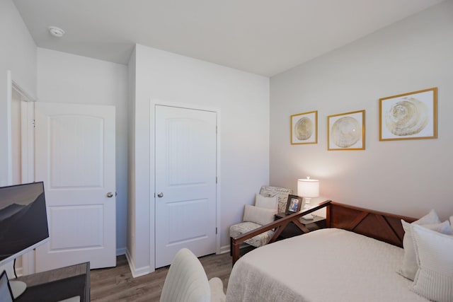 bedroom featuring baseboards and wood finished floors