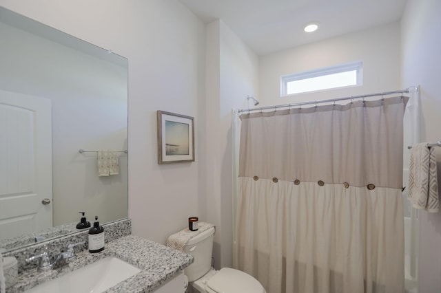 bathroom with toilet, shower / tub combo, and vanity