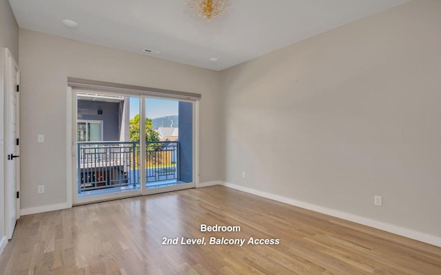 unfurnished room with light wood-type flooring and baseboards