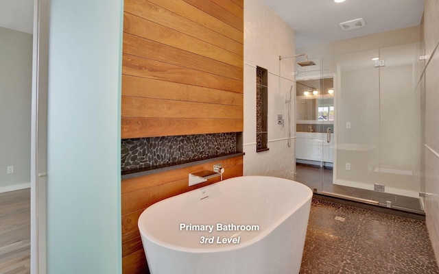 full bath featuring a freestanding tub, visible vents, and a shower stall