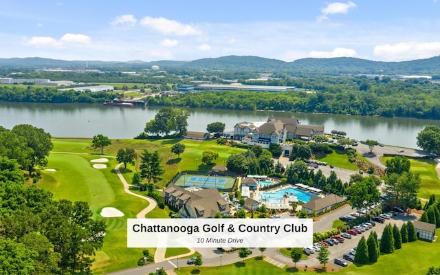 bird's eye view with view of golf course and a water and mountain view