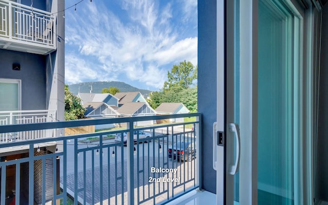 balcony with a residential view and a mountain view