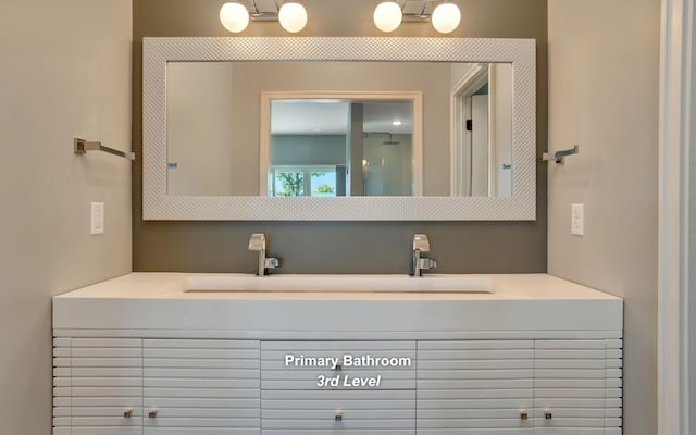 bathroom with a sink and double vanity