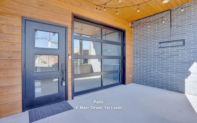 view of exterior entry with brick siding