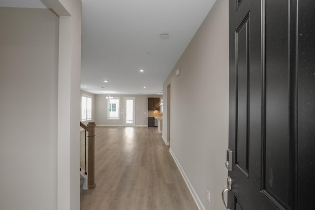 foyer featuring recessed lighting, light wood-style flooring, and baseboards