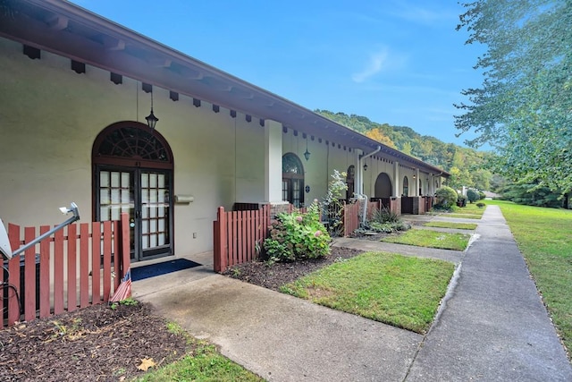 exterior space featuring french doors and stucco siding